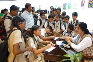 Chitra Vaidya with a group of schoolchildren visiting the show