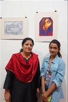 Chitra Vaidya with a student with her painting in background