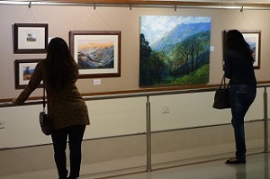 Visitors appreciating the paintings